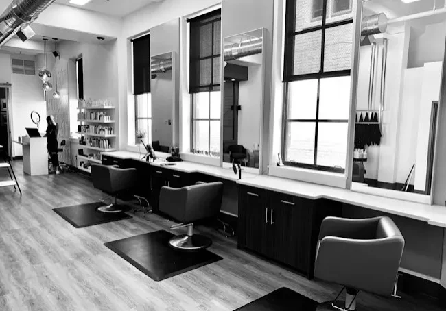 Modern barbershop interior with barber chairs and large windows