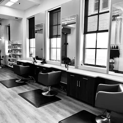 Modern barbershop interior with barber chairs and large windows