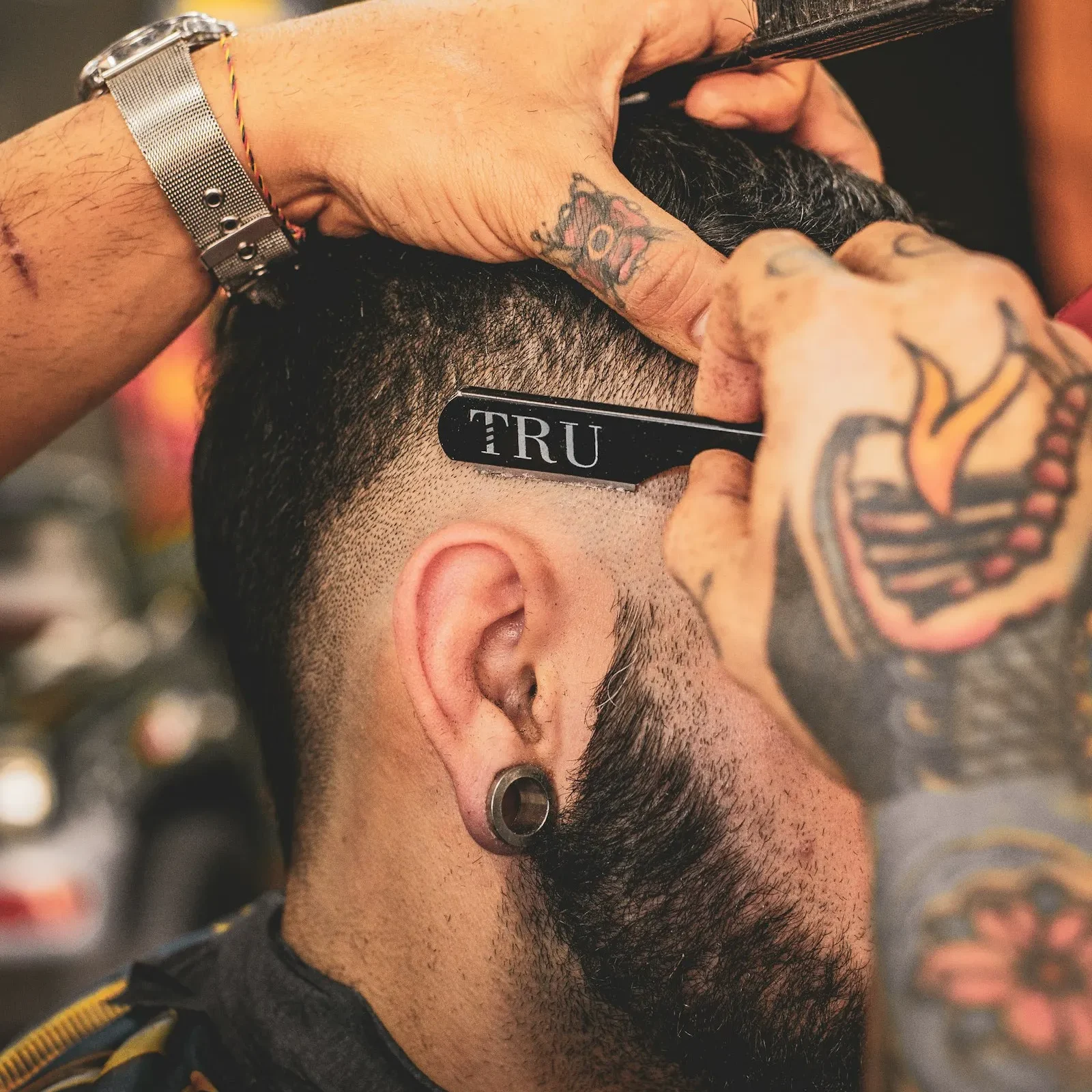 Barber trimming a client's hair with clippers