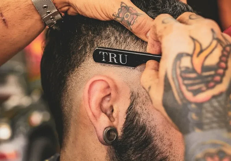 Barber carefully trimming a client's hair